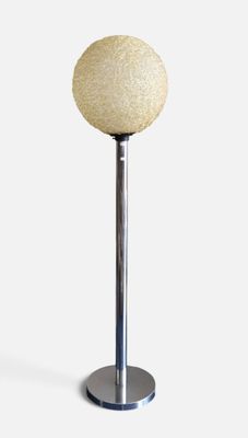 a close up of a lamp on a metal pole with a white ball