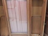 a large wooden cabinet with a mirror on top of it