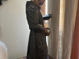 a statue of a man reading a book on a table