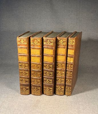 a set of five old books sitting on top of each other
