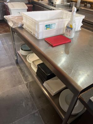 a large metal table with a bunch of dishes on it