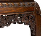 a close up of a wooden table with carvings on it