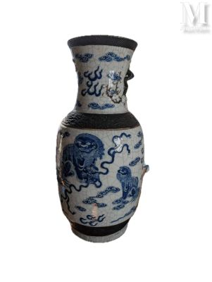 a blue and white vase sitting on a white surface
