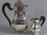a silver coffee pot and a silver tea pot