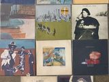 various album covers are arranged on the floor in a room