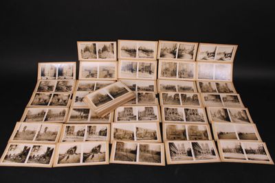a lot of old photos on a black table