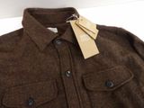 the jacket is brown and has a tag on it
