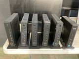 six dell desktop computers are stacked on a table in a store
