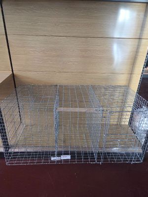 a cage that is sitting on the floor in the room