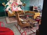 a large mural of a woman on the wall in the living room
