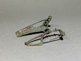 two metal scissors that are sitting on a table