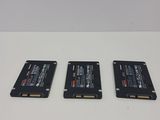 three hard drives sitting on top of a white table next to each other
