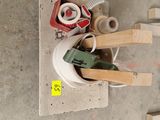 a pile of tools on the floor next to a pile of boxes