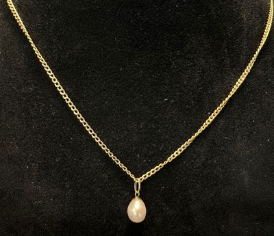a gold necklace with a pearl pendant on a mannequin mannequin mannequin mannequin mannequin mannequin mannequin manne