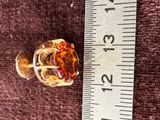 a small glass knob on a ruler next to a piece of glass