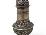 an ornate silver vase with a lid on a white background