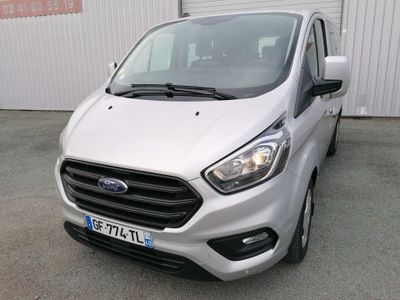 ford transit van parked in front of a building in a parking lot