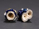 pair of blue and white porcelain vases sitting on top of a table
