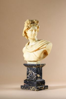 statue of a bust of a man on a pedestal with a marble base