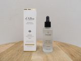 a bottle of d ' albaa anti - aging serum next to a box on a wooden table