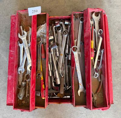 many wrenches in a red box on the floor