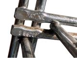 a close up of a metal chair with a bunch of screws on it