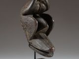 a bronze sculpture of a woman ' s head on a wooden base