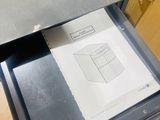 a metal drawer with a piece of paper in it