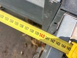 a measuring tape attached to the side of a parking meter