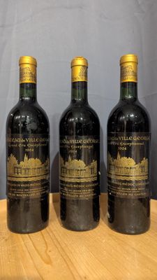 three bottles of wine sitting on top of a wooden table