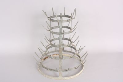a picture of a metal wine rack on a white surface