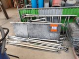 a pile of metal pipes and other items in a warehouse