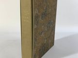 un vieux livre posé sur une table blanche à côté d'un mur blanc
