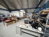 an image of a room with a lot of shelves and desks