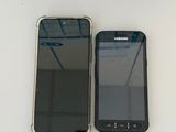 two cell phones sitting next to each other on a table