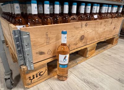 a wooden crate filled with bottles of wine on the floor