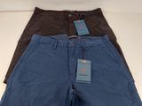 two pairs of men ' s blue and brown shorts with tags on them
