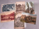 several old postcards of different buildings and buildings on a table