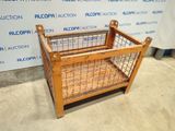 a wooden crate with a wire cage on top of it