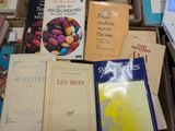many books that are sitting in a box on the floor