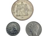 three coins are shown on a white surface with a white background
