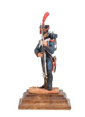 statue of a soldier in uniform with a sword on a wooden base