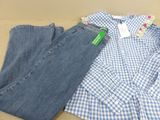 two pairs of jeans and a shirt sitting on a table