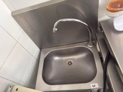 a sink in the corner of a small kitchen