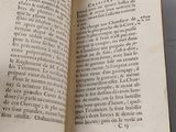 an open book on a table with a cup of coffee