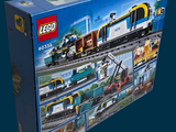a box with a lego train set in it on a blue background
