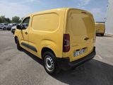 the yellow van is parked in a parking lot with other cars