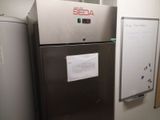 a refrigerator that is next to a dry erase board