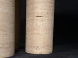 two wooden cylinders sitting next to each other on a black surface