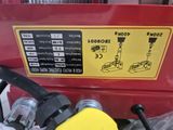 a yellow and black sign on the side of a red machine